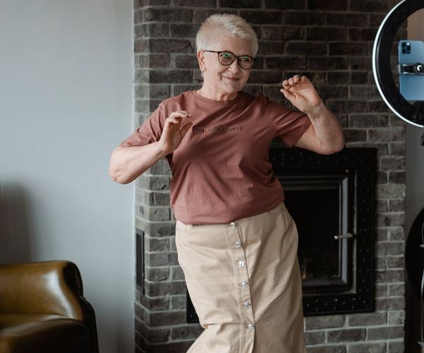 Woman feeling energetic and happy after a light cardio workout in a modern space.